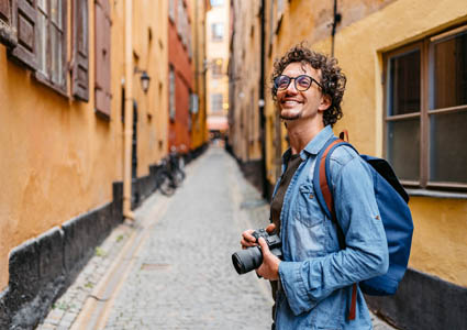Young man with camera who is traveling in another country